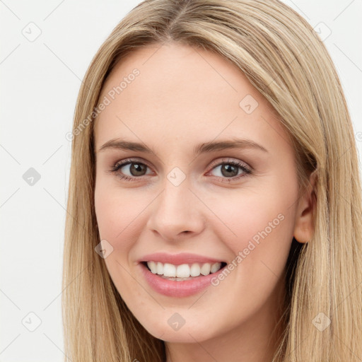 Joyful white young-adult female with long  brown hair and brown eyes