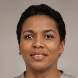 Joyful latino young-adult female with short  black hair and brown eyes