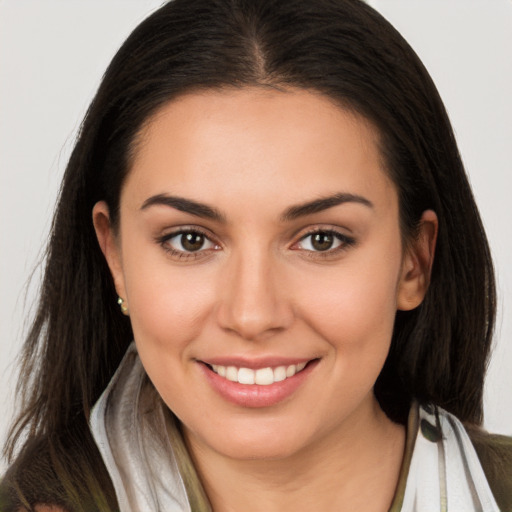 Joyful white young-adult female with long  brown hair and brown eyes