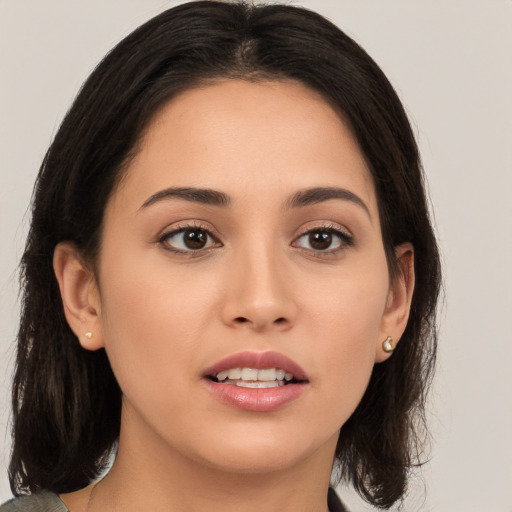 Joyful white young-adult female with medium  brown hair and brown eyes