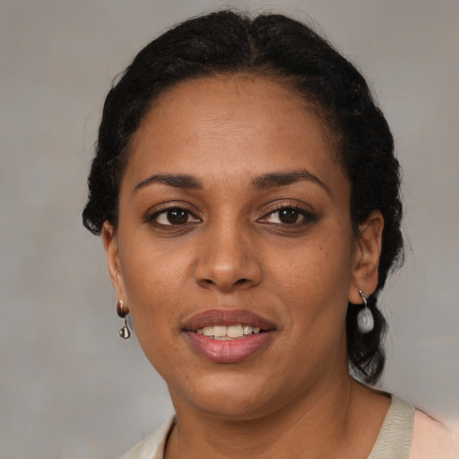 Joyful latino adult female with medium  brown hair and brown eyes