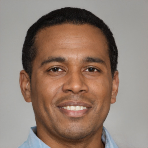Joyful latino adult male with short  brown hair and brown eyes