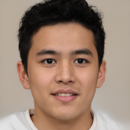 Joyful latino young-adult male with short  brown hair and brown eyes