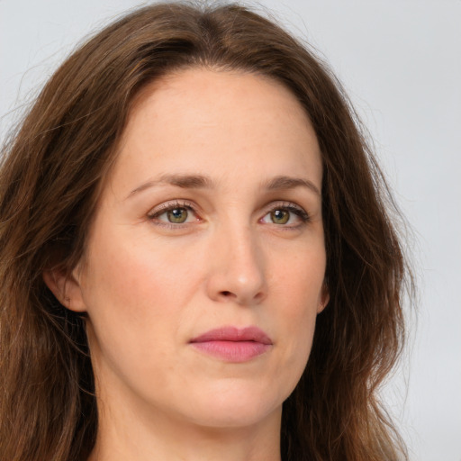 Joyful white young-adult female with long  brown hair and green eyes