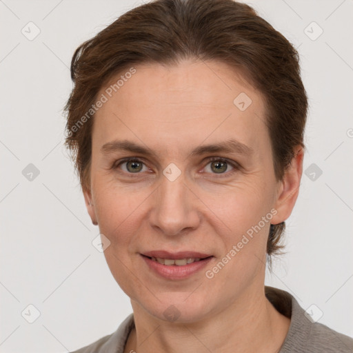 Joyful white adult female with short  brown hair and grey eyes