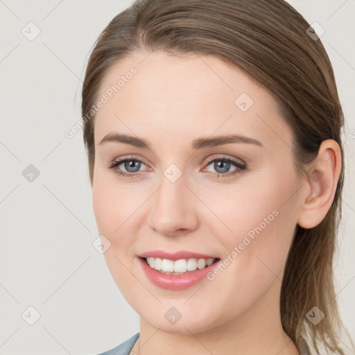 Joyful white young-adult female with long  brown hair and grey eyes