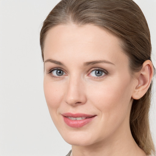 Joyful white young-adult female with long  brown hair and grey eyes