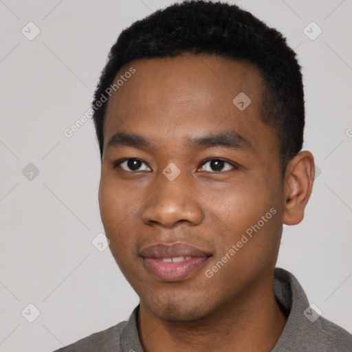 Joyful black young-adult male with short  black hair and brown eyes