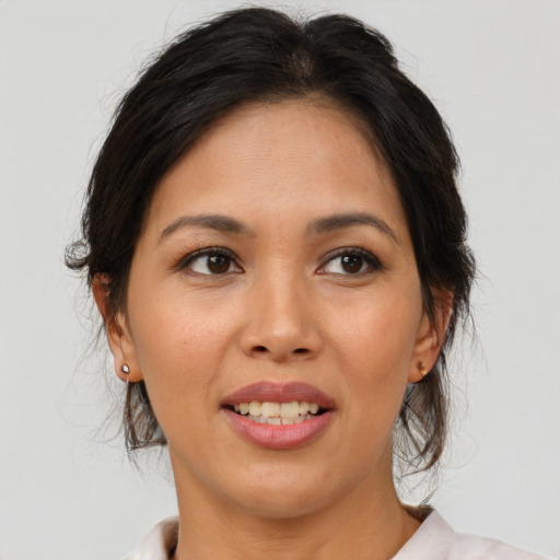 Joyful white young-adult female with medium  brown hair and brown eyes