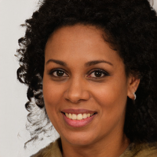 Joyful black young-adult female with medium  brown hair and brown eyes