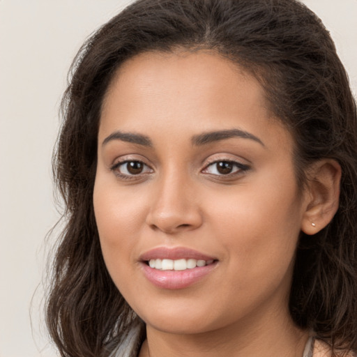 Joyful white young-adult female with long  brown hair and brown eyes