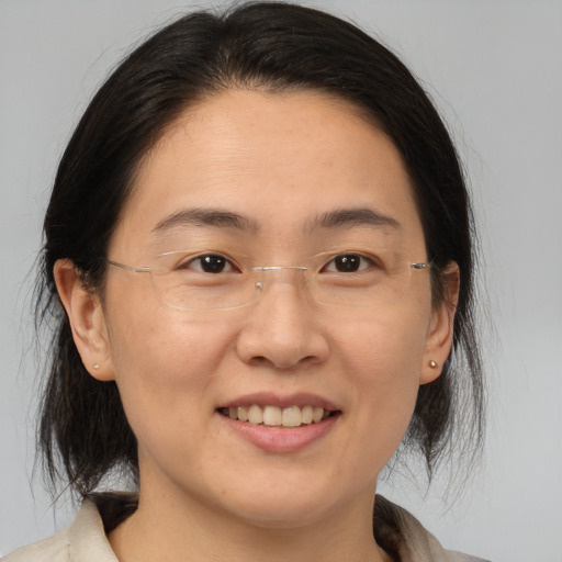 Joyful white adult female with medium  brown hair and brown eyes