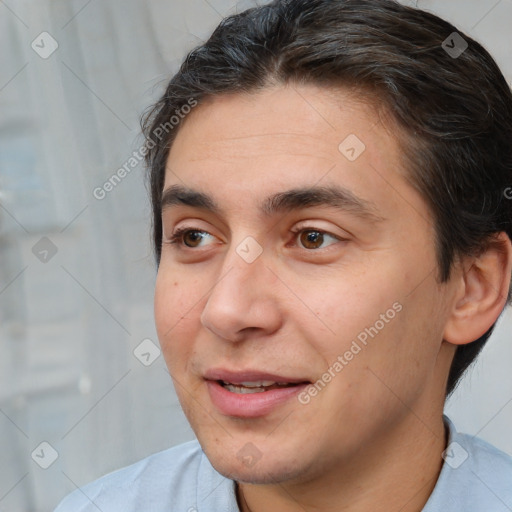 Joyful white adult male with short  brown hair and brown eyes