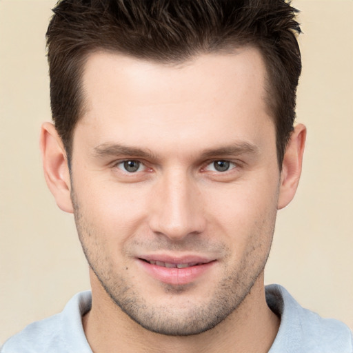 Joyful white young-adult male with short  brown hair and brown eyes