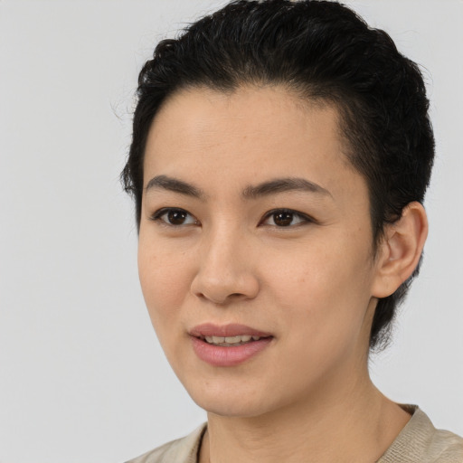 Joyful latino young-adult female with short  black hair and brown eyes