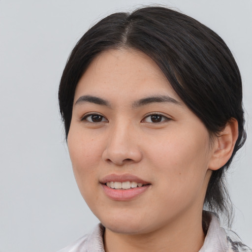 Joyful asian young-adult female with medium  brown hair and brown eyes