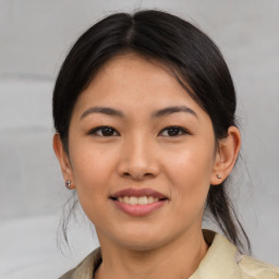 Joyful asian young-adult female with medium  brown hair and brown eyes