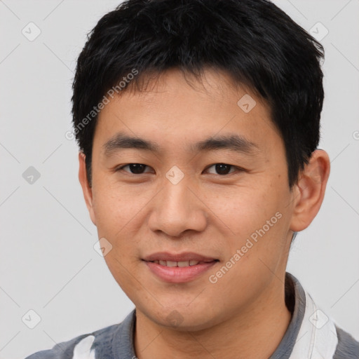 Joyful asian young-adult male with short  black hair and brown eyes