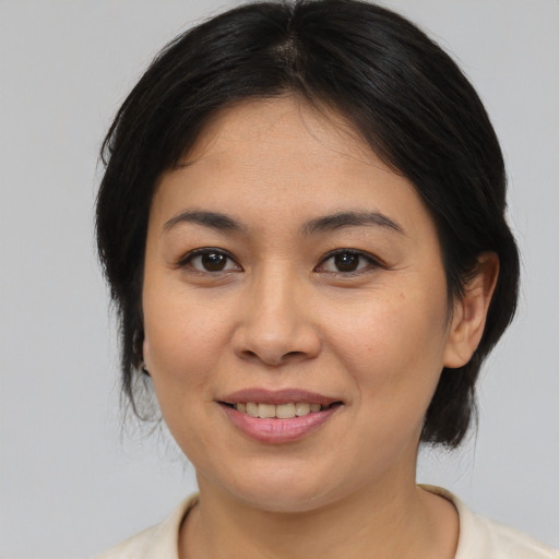 Joyful asian young-adult female with medium  brown hair and brown eyes