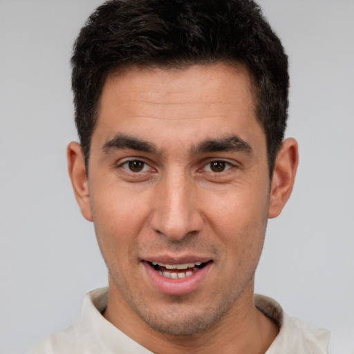 Joyful white young-adult male with short  brown hair and brown eyes