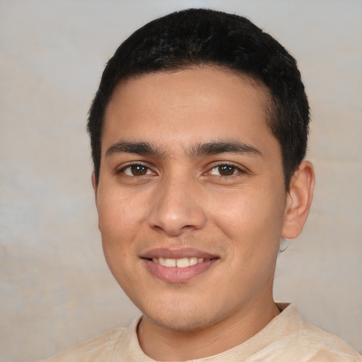 Joyful latino young-adult male with short  black hair and brown eyes