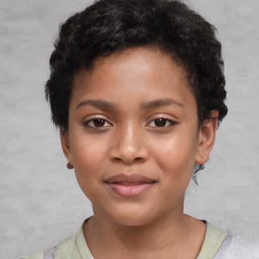 Joyful black child female with short  black hair and brown eyes