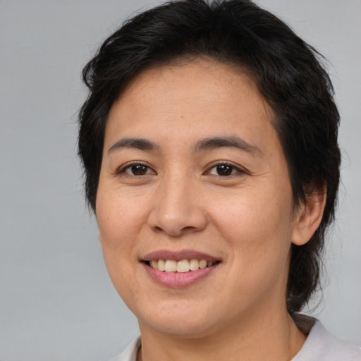 Joyful asian young-adult female with medium  brown hair and brown eyes
