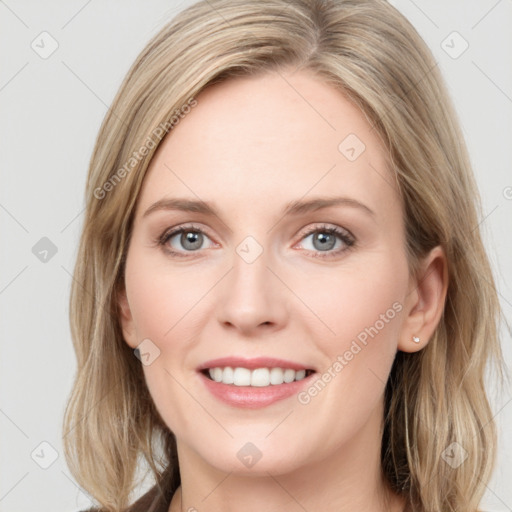 Joyful white young-adult female with long  brown hair and blue eyes