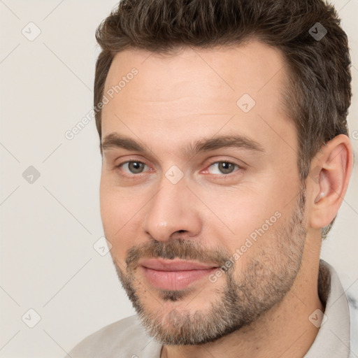 Joyful white adult male with short  brown hair and brown eyes