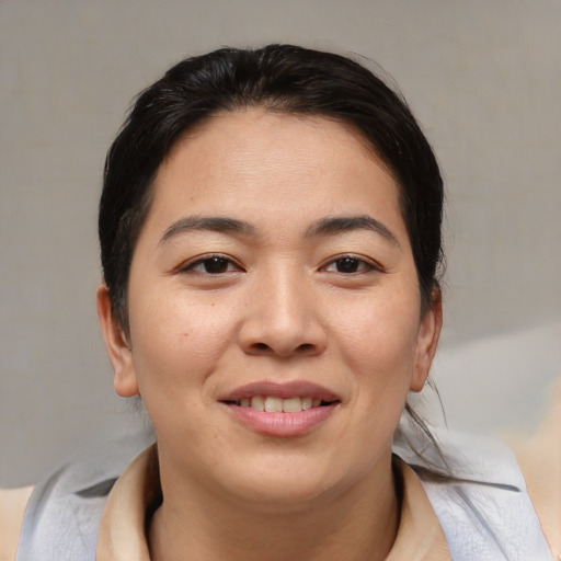 Joyful asian young-adult female with medium  brown hair and brown eyes