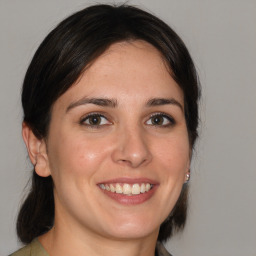 Joyful white young-adult female with medium  brown hair and brown eyes