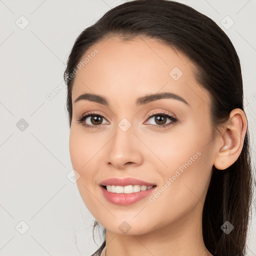 Joyful white young-adult female with long  brown hair and brown eyes