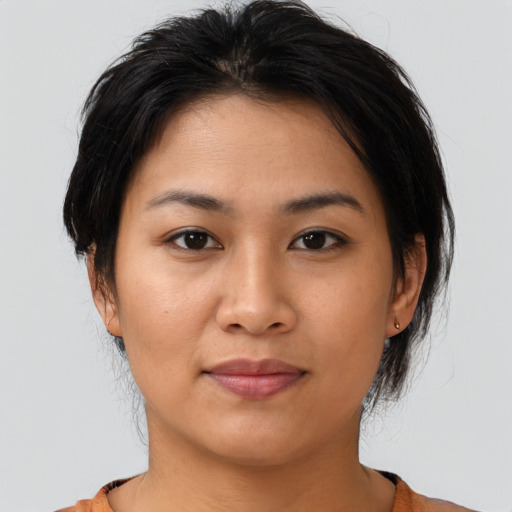 Joyful asian young-adult female with medium  brown hair and brown eyes