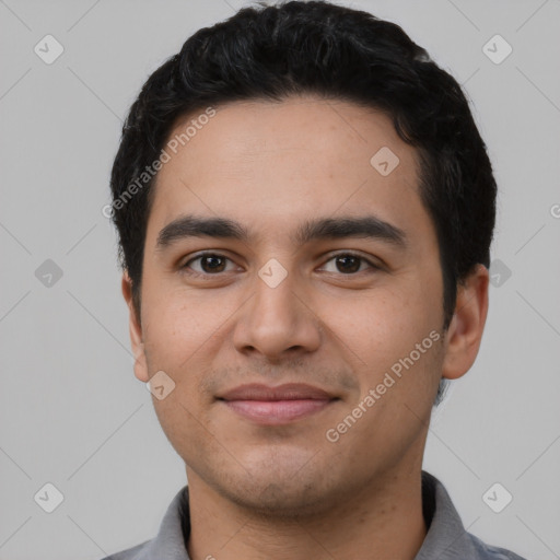 Joyful latino young-adult male with short  black hair and brown eyes