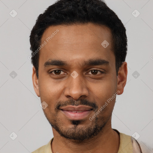 Joyful black young-adult male with short  black hair and brown eyes