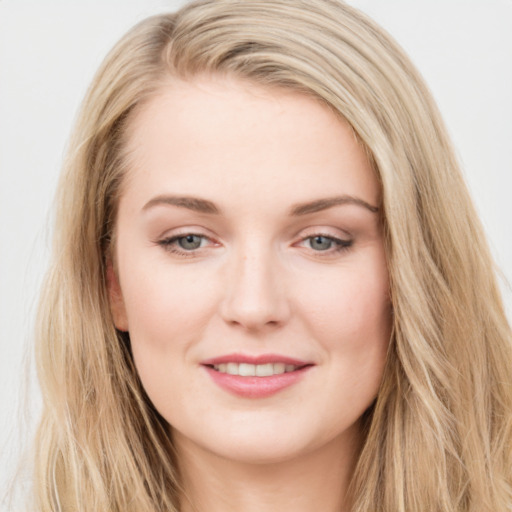 Joyful white young-adult female with long  brown hair and blue eyes