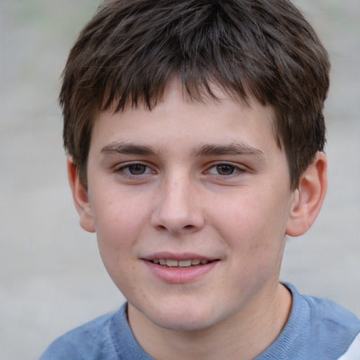 Joyful white child male with short  brown hair and grey eyes