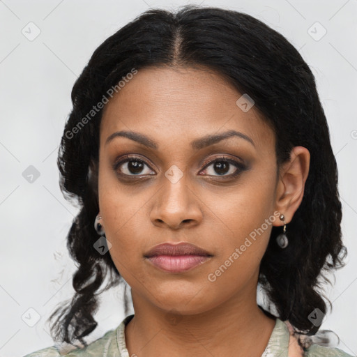 Joyful black young-adult female with long  black hair and brown eyes