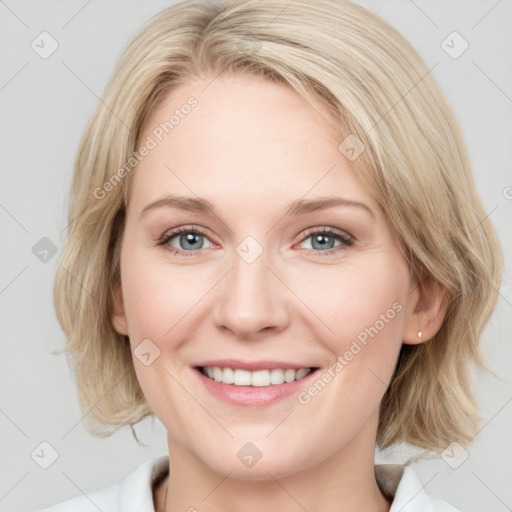 Joyful white young-adult female with medium  brown hair and blue eyes