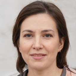 Joyful white adult female with medium  brown hair and brown eyes