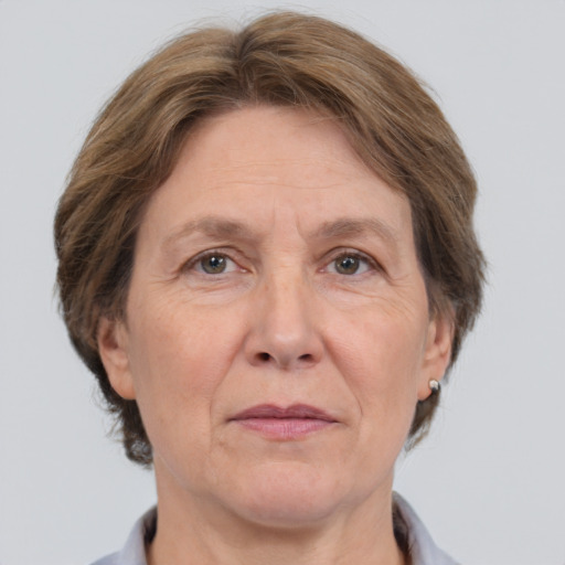 Joyful white middle-aged female with short  brown hair and grey eyes