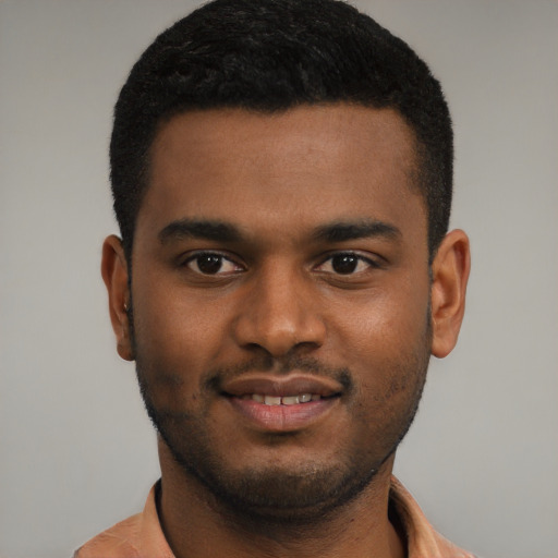 Joyful black young-adult male with short  black hair and brown eyes