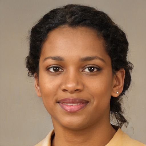Joyful black young-adult female with medium  black hair and brown eyes