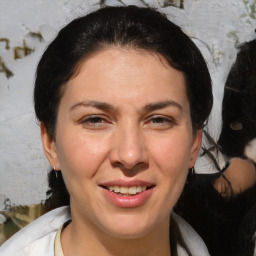 Joyful white adult female with medium  brown hair and brown eyes