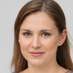 Joyful white young-adult female with medium  brown hair and grey eyes