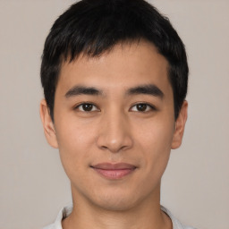 Joyful asian young-adult male with short  black hair and brown eyes