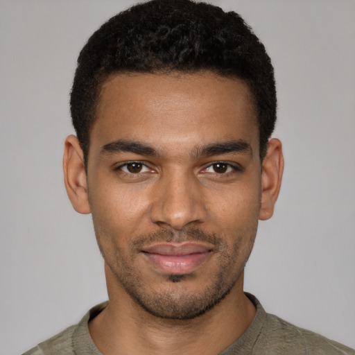 Joyful black young-adult male with short  black hair and brown eyes