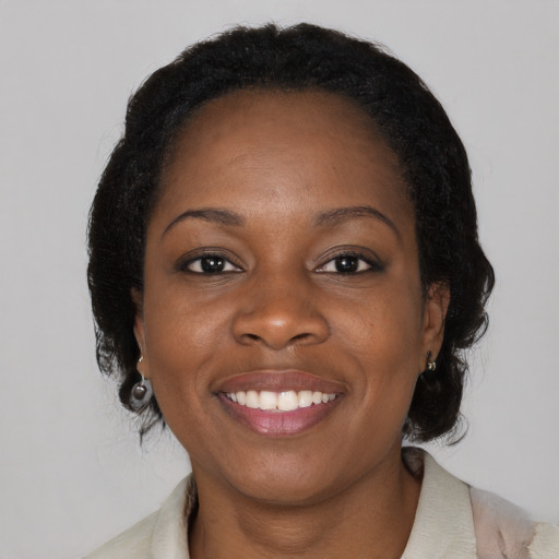 Joyful black young-adult female with medium  black hair and brown eyes