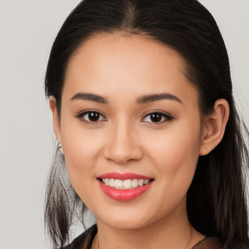 Joyful white young-adult female with long  brown hair and brown eyes