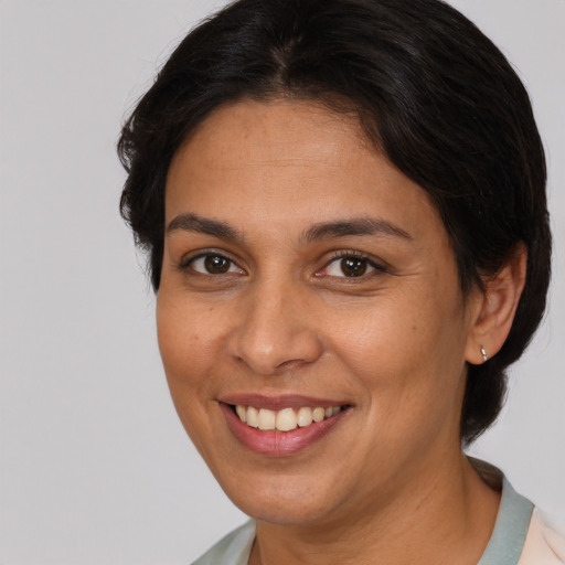 Joyful white adult female with short  brown hair and brown eyes